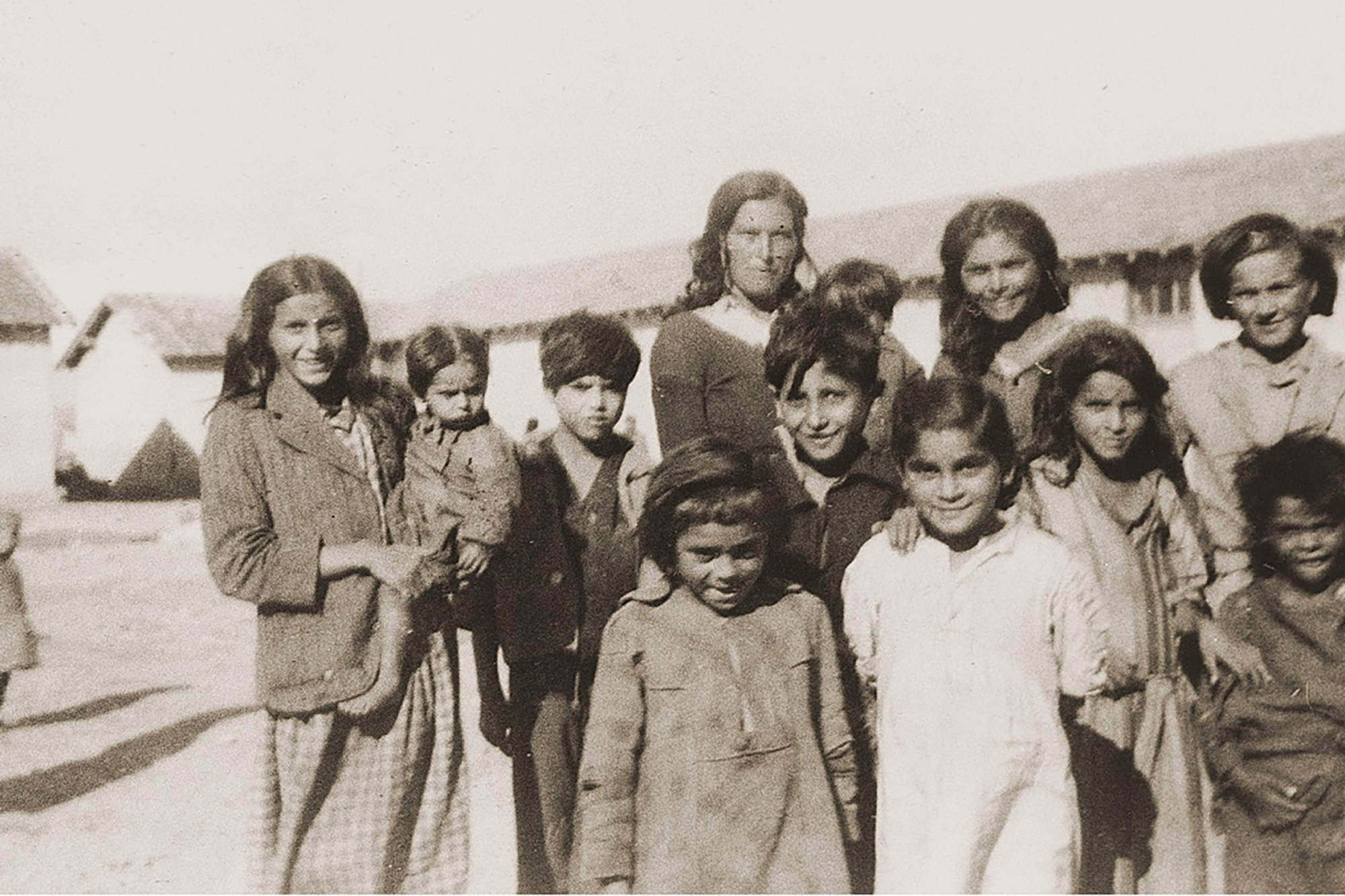 A group of Roma women and children in a military camp during World War II.