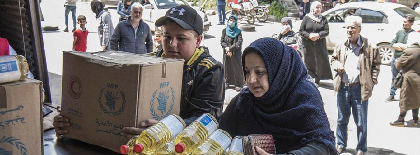 A family picking up food from World Food Programme distribution center in Syria.